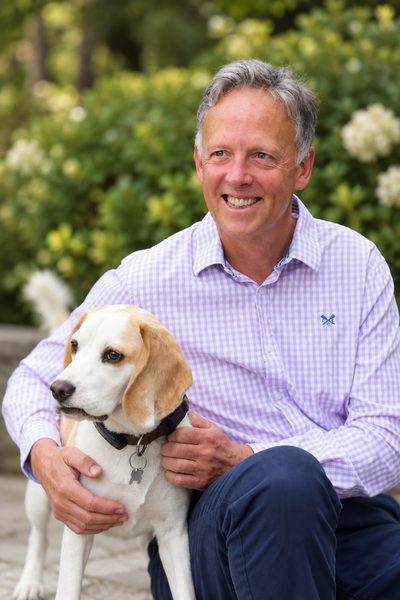 Andrew Hart outdoors with a beagle